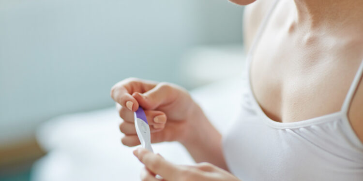 Can a woman still be pregnant if she has a period?